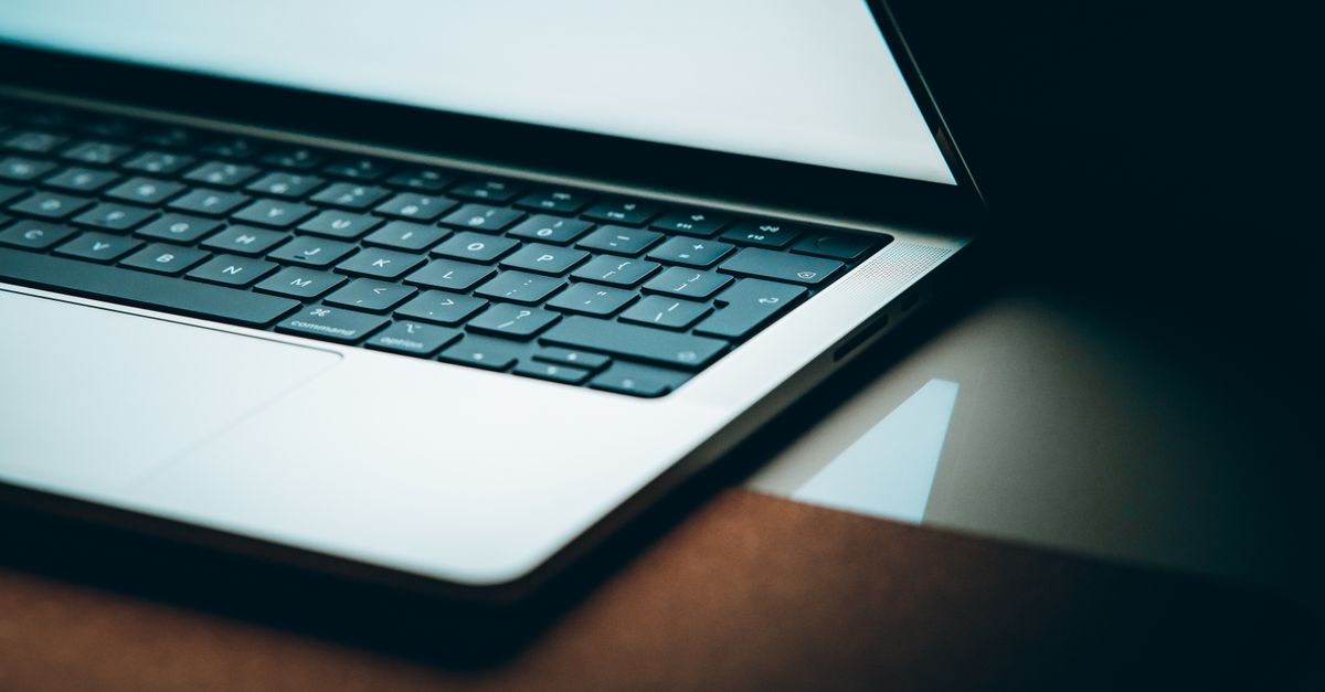 Close-up of a modern laptop keyboard with a backlit display, emphasizing sleek design.