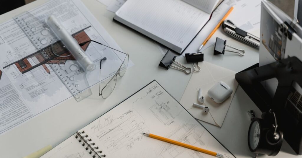 A busy architectural workspace featuring blueprints, sketches, and drafting tools.