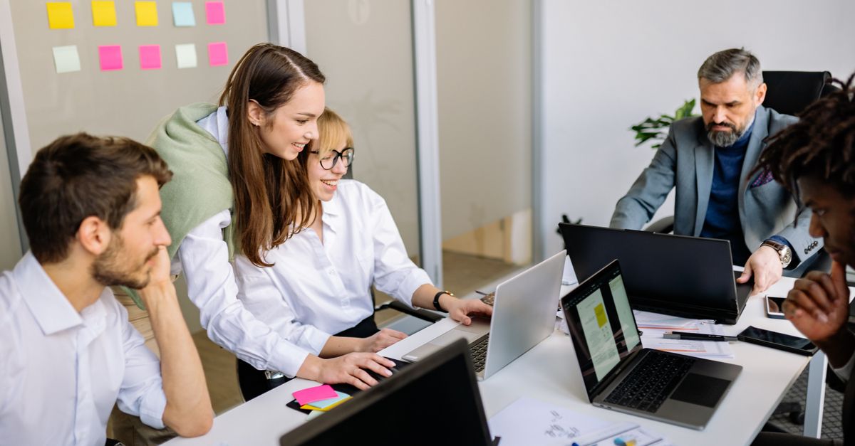 Diverse team of business professionals collaborating in a modern office setting.