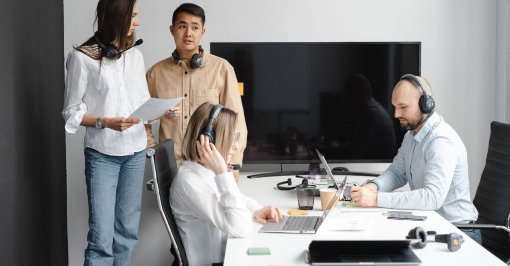 Group of call center agents working together in a modern office setting.