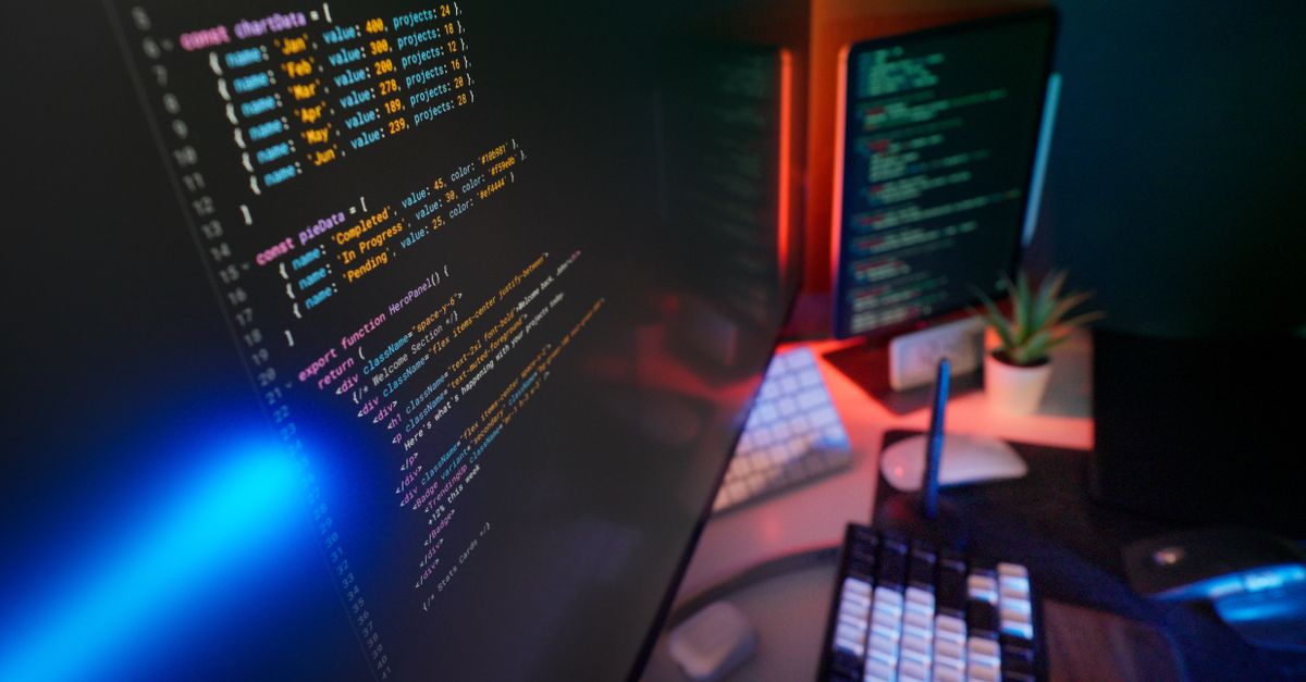 A vibrant workspace featuring colorful code on computer monitors, ideal for developers.