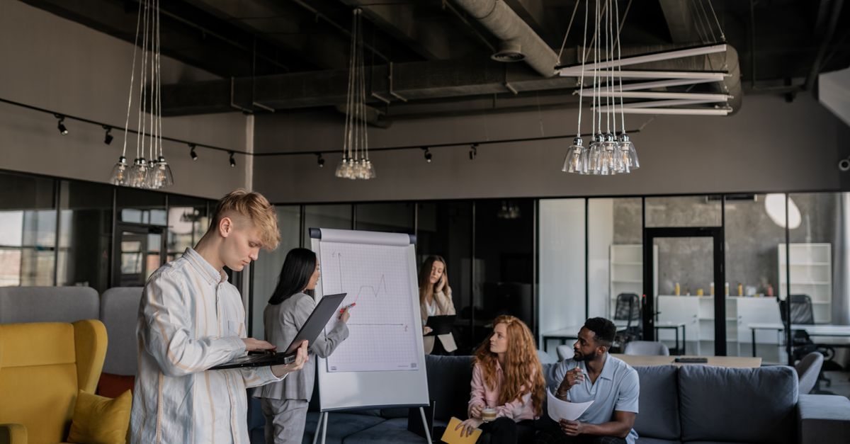 A diverse group of professionals collaborating during a business meeting in an open-plan office.