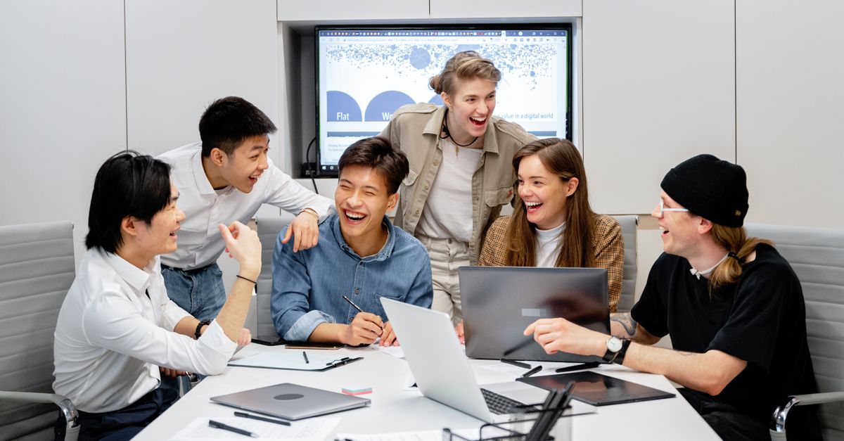 A diverse group of professionals engaging in brainstorming and teamwork in an office environment.