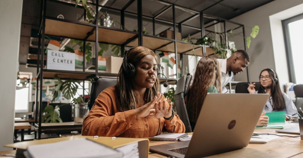 Diverse call center team working collaboratively in a modern office environment.