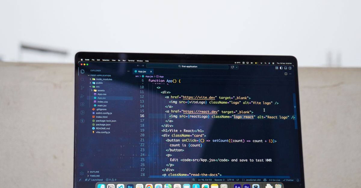 Laptop displaying code outdoors, ideal for remote work or freelance programming.