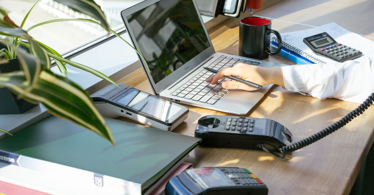 A bright modern office desk setup with electronic devices and plants, ideal for productivity.