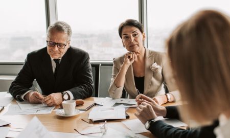 Business professionals in discussion during a meeting in a modern office setting.