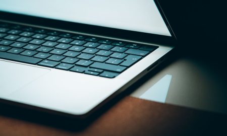 Close-up of a modern laptop keyboard with a backlit display, emphasizing sleek design.