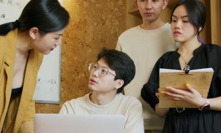A group of professionals exchanging ideas during a business meeting indoors.