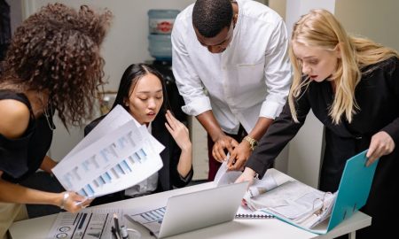 A diverse team of professionals engaged in a collaborative meeting at a modern office space.