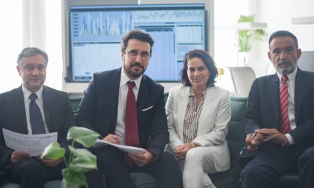 Professional team in corporate attire ready for a meeting, engaged in discussion.