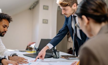 A diverse team engaged in a business meeting, fostering collaboration and teamwork in an office setting.