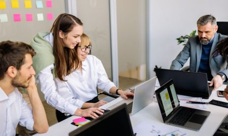 Diverse team of business professionals collaborating in a modern office setting.