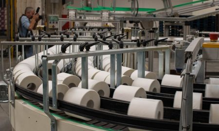 Photographer captures a production line for toilet paper in an industrial setting.