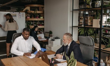 Professional team engaged in a business meeting with diverse members in a modern office environment.