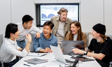 A diverse group of professionals engaging in brainstorming and teamwork in an office environment.
