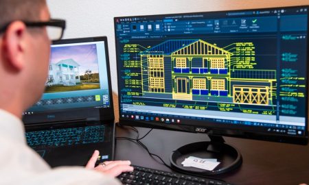 An architect reviews detailed house designs on dual monitors in a modern office setting.