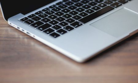A sleek laptop on a wooden surface, showcasing elegant design and technology.