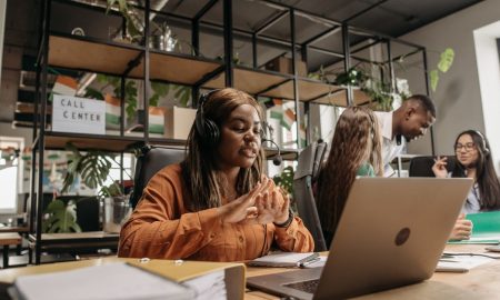Diverse call center team working collaboratively in a modern office environment.