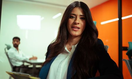 Professional woman in a modern office environment engaging in a business meeting.
