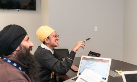 A professional team of colleagues engaging in a meeting, fostering teamwork and collaboration.