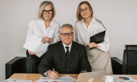 Senior professionals in a business meeting, discussing charts and data in the office.
